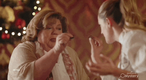 an advertisement for hallmark mysteries shows two women fighting