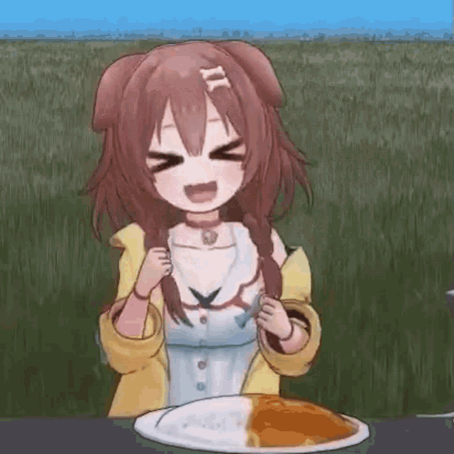 a girl is sitting at a table with a plate of curry .