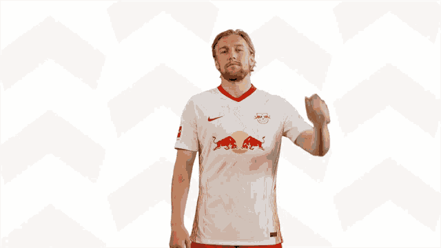 a soccer player wearing a white shirt with red bulls on it