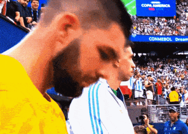 a man stands in front of a screen that says copa america on it
