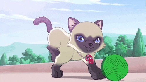 a cat with blue eyes is playing with a green ball of yarn