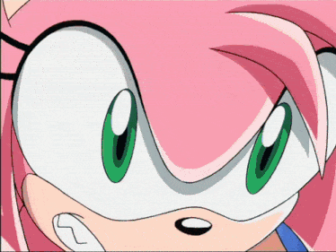 a close up of a cartoon character 's face with green eyes
