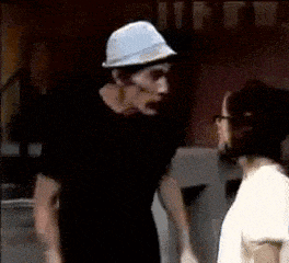 a man wearing a hard hat is talking to a woman .