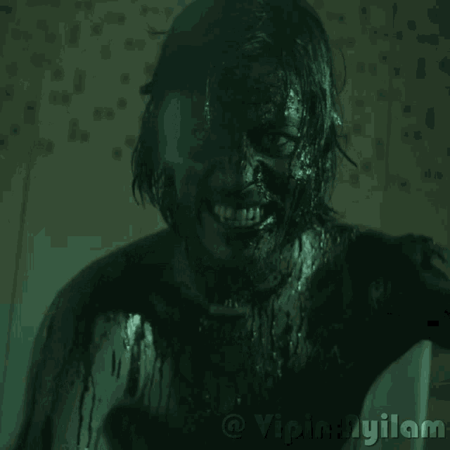 a picture of a person with black paint on their face is taken by vipin vijayan
