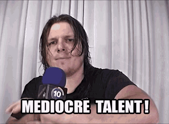 a man holding a microphone with the words mediocre talent written below him