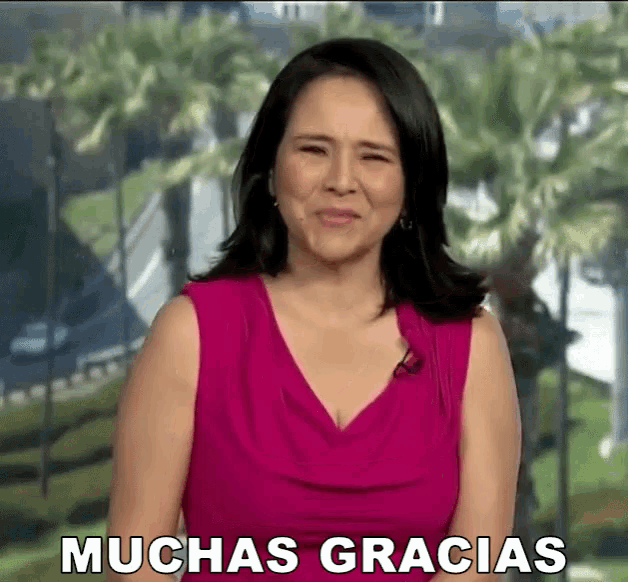 a woman in a pink top says muchas gracias in front of palm trees
