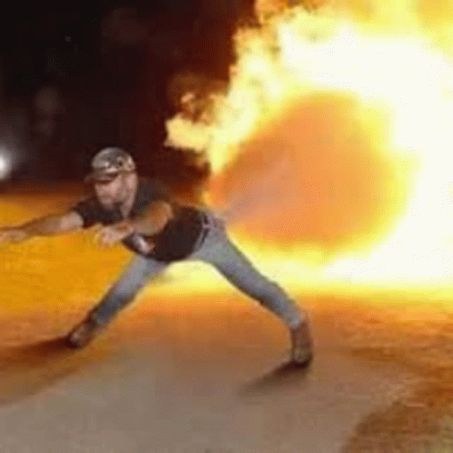 a man is throwing a fireball at a car .