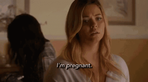 a woman is sitting in a room talking to another woman .