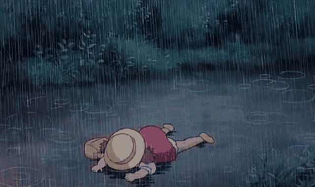 a little girl is laying in the rain wearing a straw hat