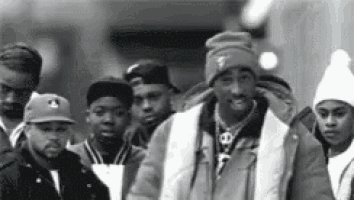a group of people are standing next to each other on a street .