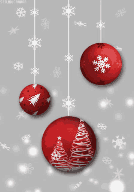 three red christmas ornaments with snowflakes on them hang from a string