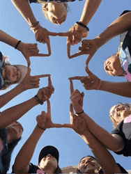 a group of people making a cross with their fingers