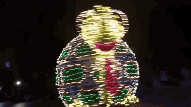 a person is dancing in front of a display of lights