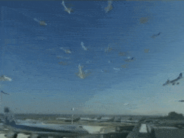 a large passenger jet is sitting on a runway with other planes in the background