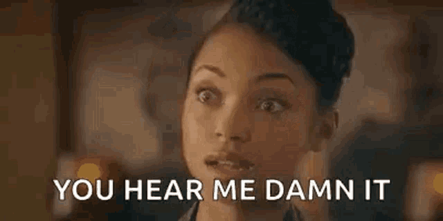 a close up of a woman 's face with the words `` you hear me damn it '' .