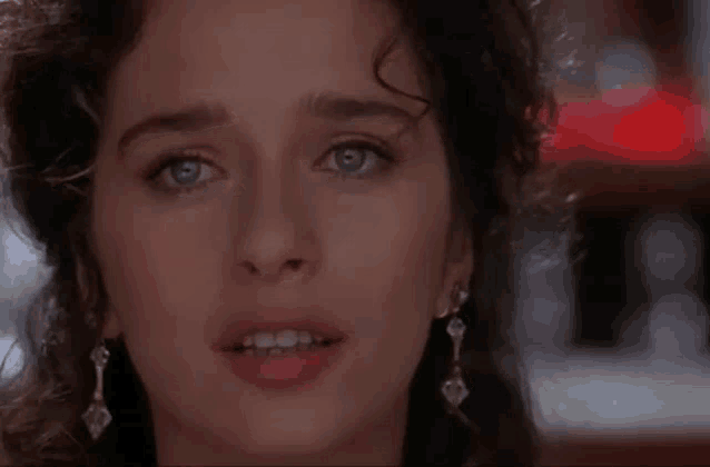 a close up of a woman 's face with tears running down her face