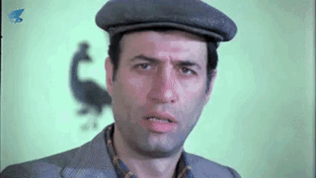 a close up of a man wearing a hat and a suit .