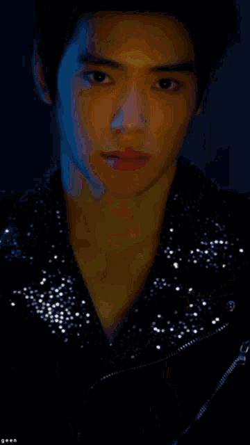 a close up of a man 's face with his hand on his face