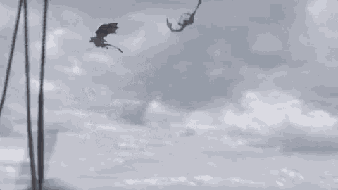 a dragon is flying over a body of water with a boat in the background