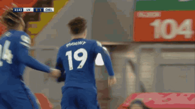 a soccer player with the number 3 on his jersey is kneeling on the field