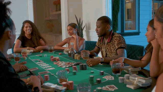 a group of people are playing a game of poker with a green table cloth