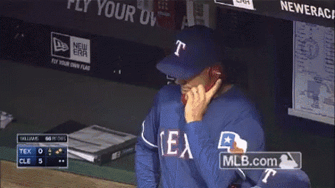 a man in a texas jersey is talking on a phone