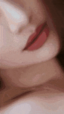 a close up of a woman 's lips and neck