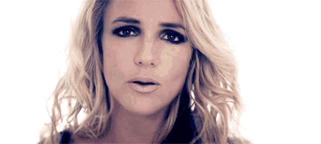 a close up of a woman 's face with a serious look on her face