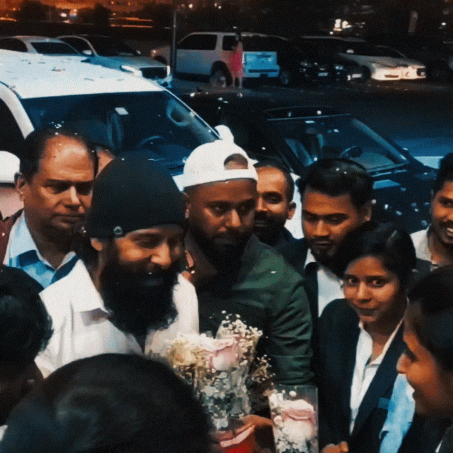 a man with a beard is holding a bouquet of flowers in a crowd