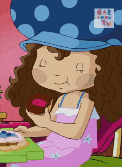 a girl with curly hair is eating a cupcake from a cartoon