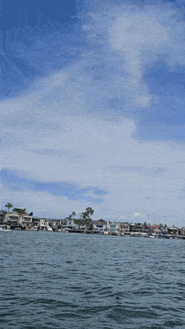a body of water with houses in the background