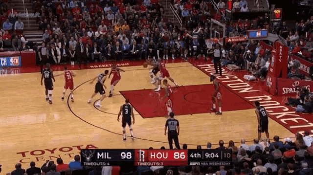 a basketball game is being played on a court that says toyota center