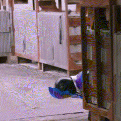 a blurry picture of a person laying on the ground in front of a fence