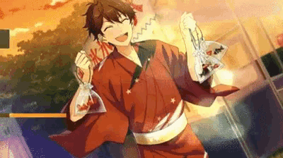 a young man in a red kimono is holding a bag of fish .