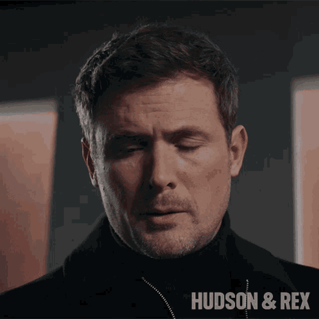 a close up of a man 's face with the words hudson & rex in the corner