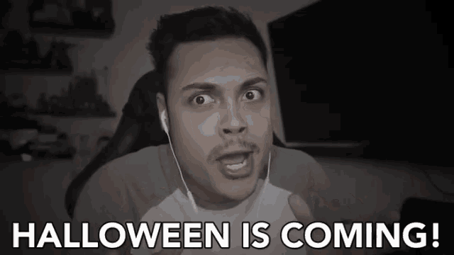 a man with ear buds says " halloween is coming "
