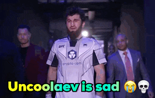 a man in a ufc jersey is walking down a hallway