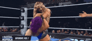 two women wrestling in a ring with the words royal rumble on the bottom right