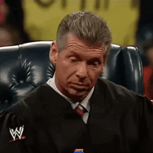 a man in a suit and tie is sitting in a chair .