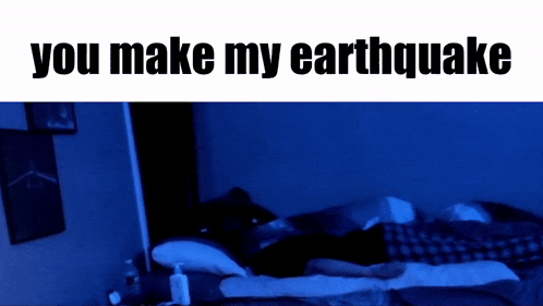 a person is laying on a bed with the words you make my earthquake above them