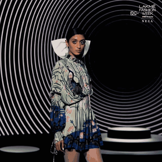 a model walks down a runway at the lakme fashion week
