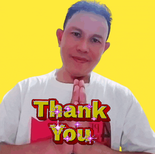 a man wearing a white shirt with the words thank you on it
