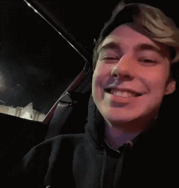 a close up of a man 's face in a car with his eyes closed
