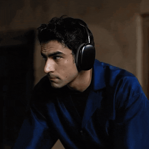 a man wearing headphones is looking at the camera