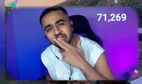 a man with a beard is wearing headphones and giving a thumbs up sign