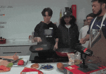 a man wearing a ny hat is cooking