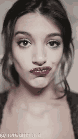 a woman with purple lipstick is making a funny face with the hashtag @nereamagna