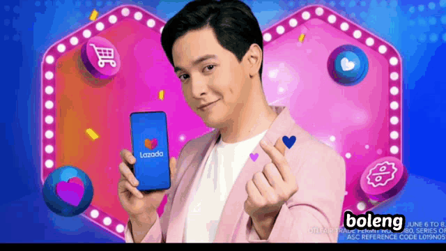 a man in a pink jacket holds a lazada phone