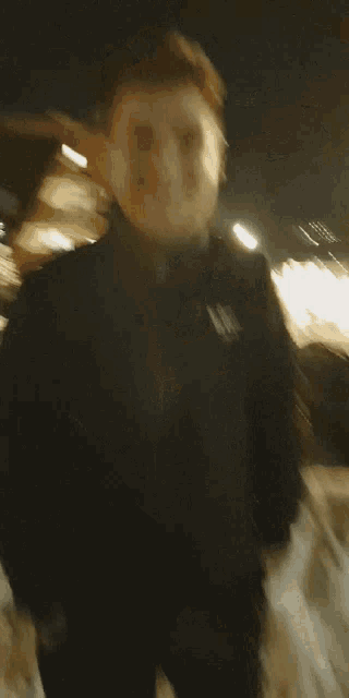 a blurry picture of a person walking in the snow at night