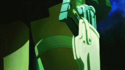 a close up of a person 's hand holding a green object